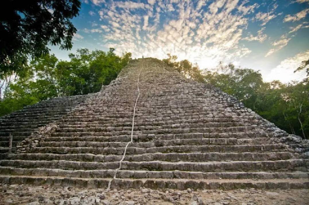 Coba archaeological site with jungle canopy and stone pyramid