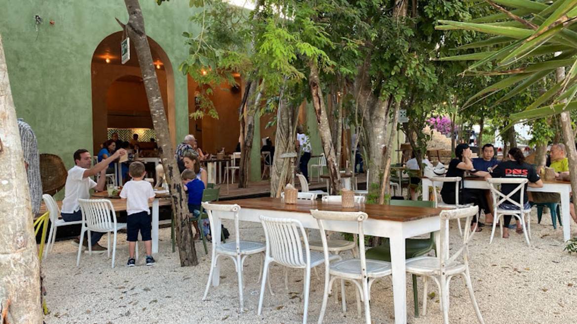 Burrito Amor's colorful garden dining patio in Tulum town