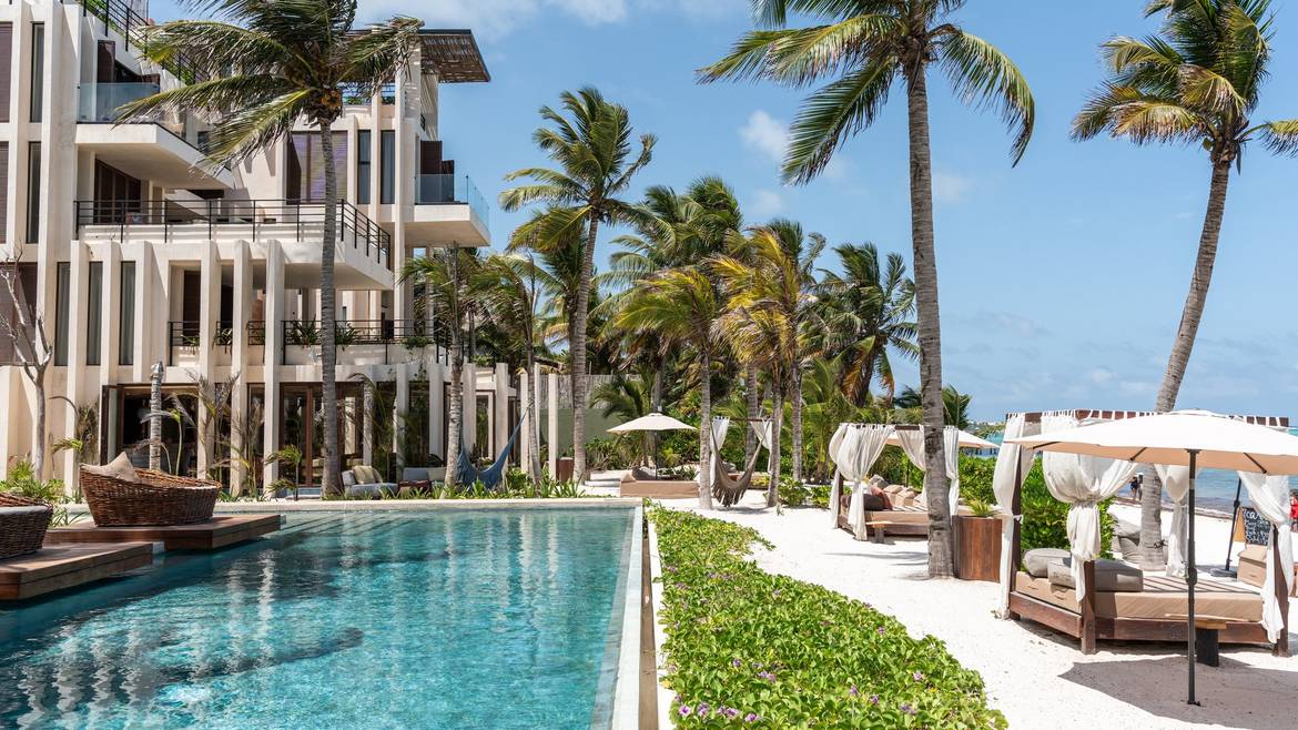 Pool and palm-lined beach at Bespoke Tulum near Tankah