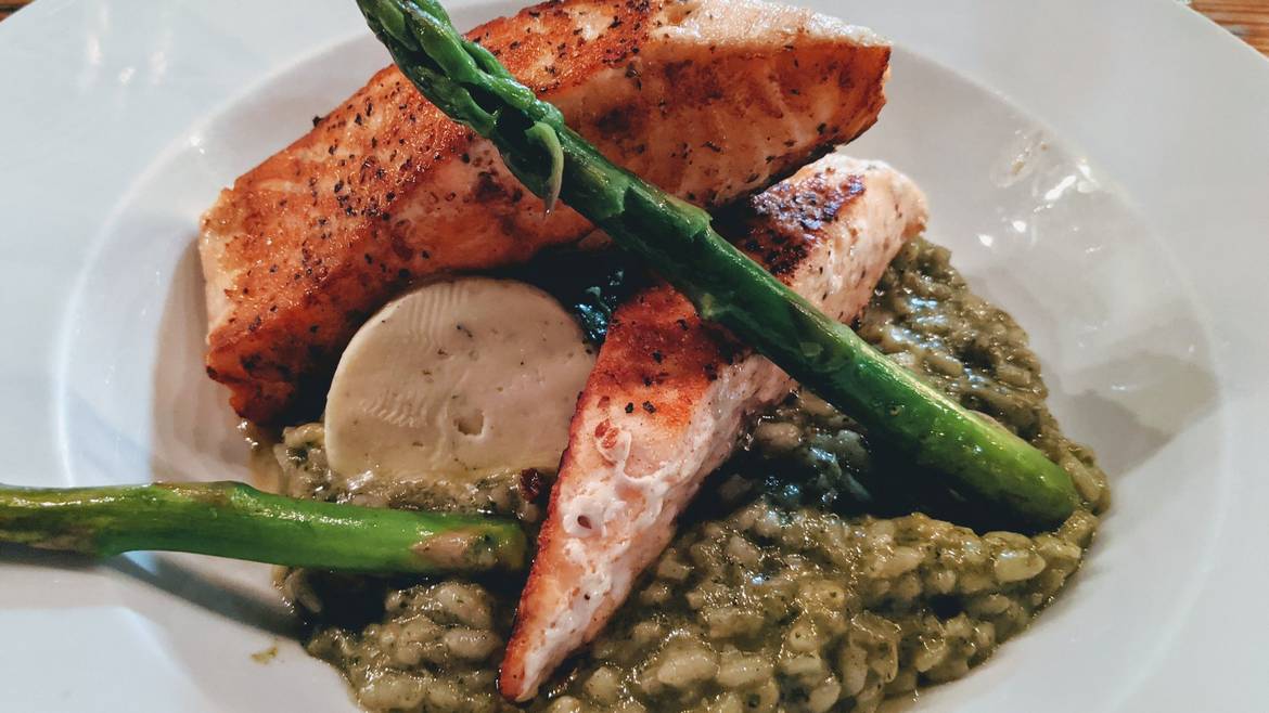 Grilled salmon over risotto at Chacabar in Aldea Zama