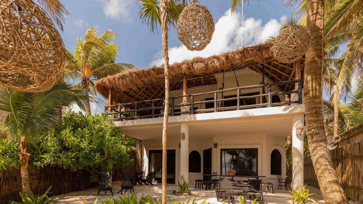 NEST Tulum beachfront building among the palms